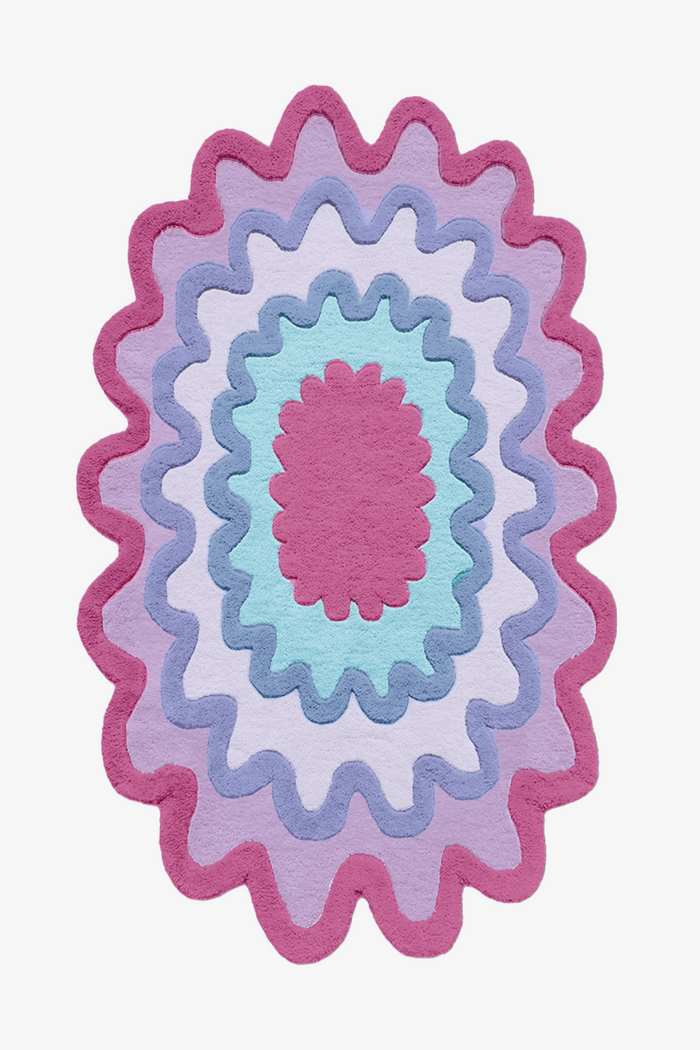 Bright rainbow scalloped wool rug in pink, red, blue, and cream, colorful modern wool area rug for eclectic interiors