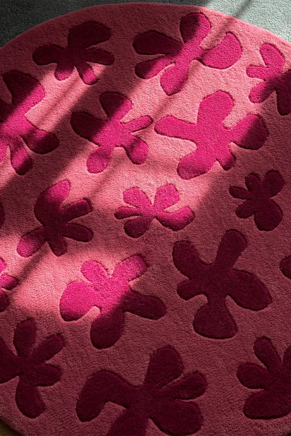 Close-up of pink flower textured round wool rug, colorful funky rug for cozy modern spaces lifestyle
