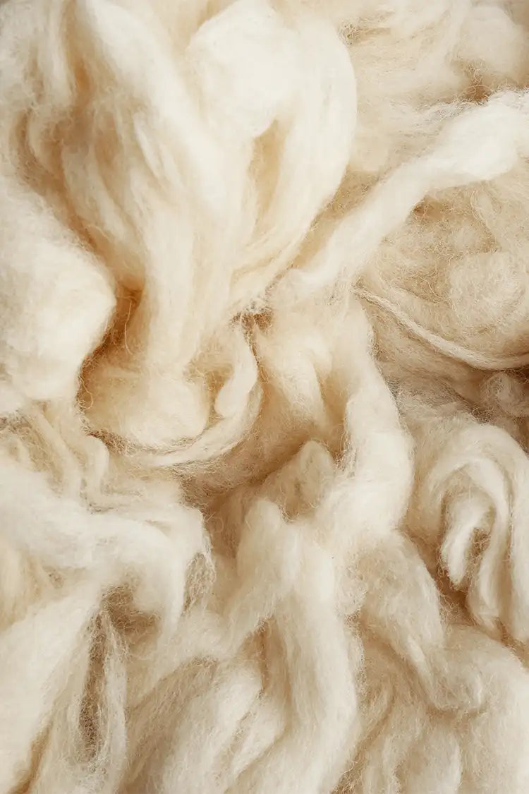 Bundles of sustainably sourced New Zealand wool in natural tones.