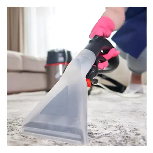 A steam cleaner being used on a carpet for deep cleaning and revitalization.