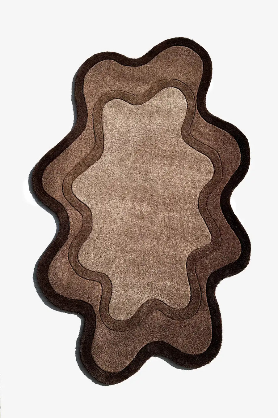 Wavy brown irregular shaped rug in layered neutral tones – organic modern area rug for moody living room or bedroom

