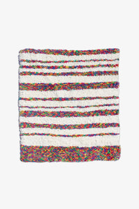 Striped cotton rug in rainbow and cream tones, great as a 4x6 rug, nursery rug, or modern runner rug for hallways or bedrooms