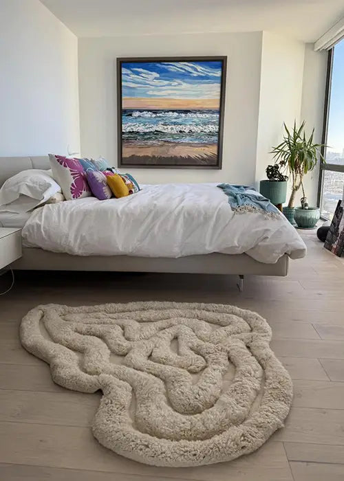 Rolling Tides Shag Rug in ivory, placed in a light-filled bedroom with coastal decor.
