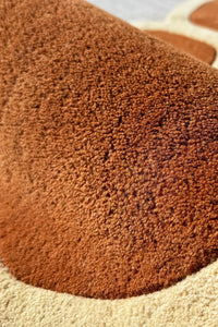 Plush wool pile of a large brown abstract shaped rug, a decorative funky rug for contemporary or Japandi living rooms