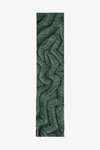 Green sculptural wool shag runner rug with irregular wavy carved design, perfect for modern hallways or entryways