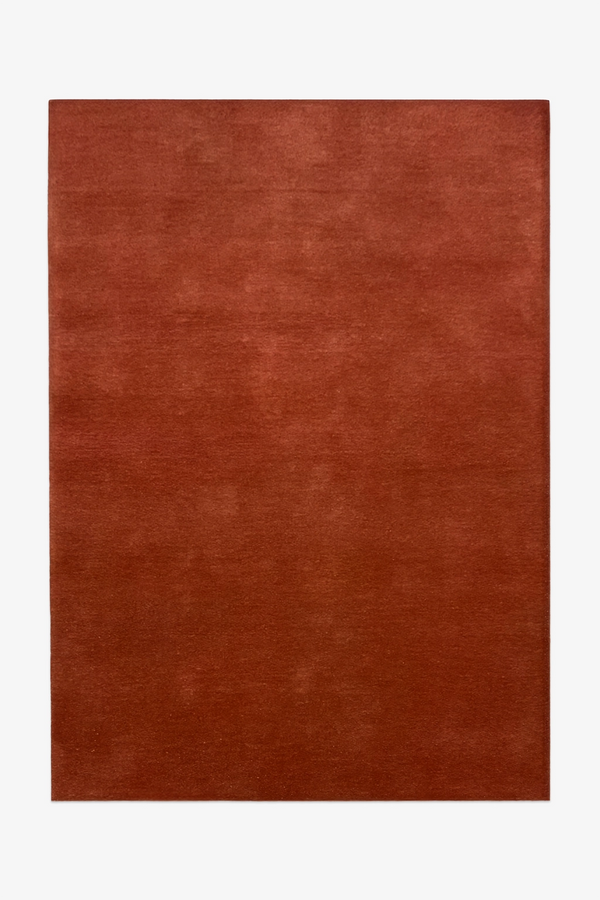 Burnt orange wool area rug in 8x10 size, perfect for cozy boho living rooms, modern bedrooms, and dining spaces