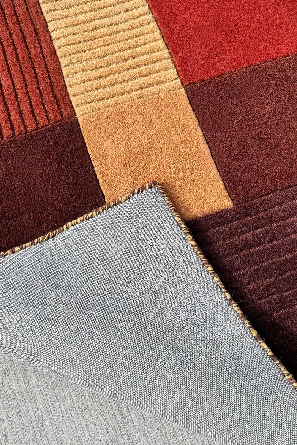 soft high pile tufted wool area rug with warm neutral earth tone color block details