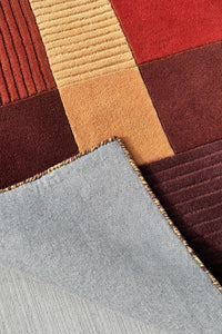 soft high pile tufted wool area rug with warm neutral earth tone color block details