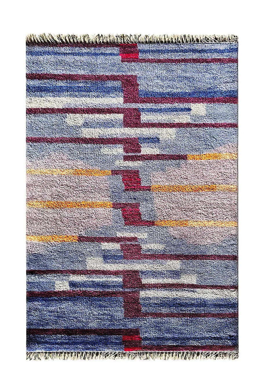 Modern blue and burgundy wool area rug with bold geometric and striped patterns