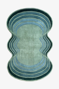 Blue and green wavy abstract rug with scalloped edges, a modern irregular shaped wool rug for colorful living rooms or bedrooms


