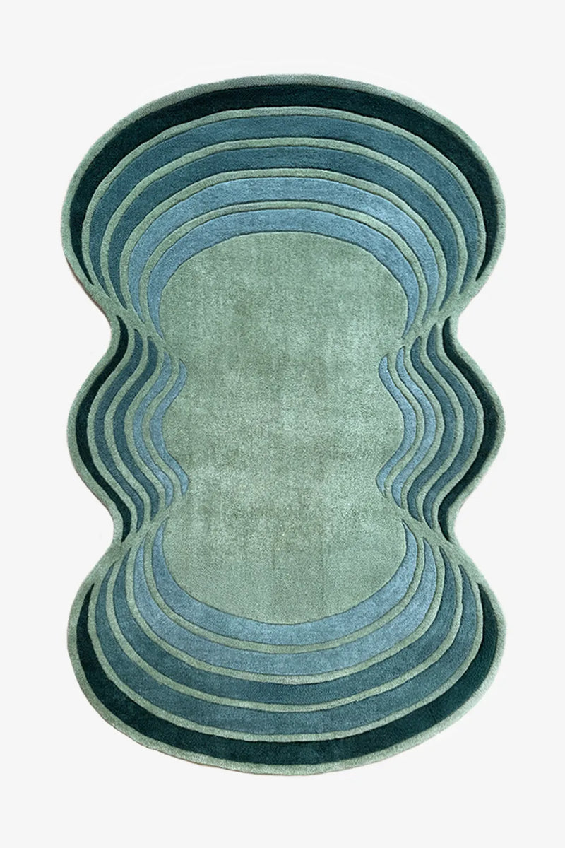 Blue and green wavy abstract rug with scalloped edges, a modern irregular shaped wool rug for colorful living rooms or bedrooms

