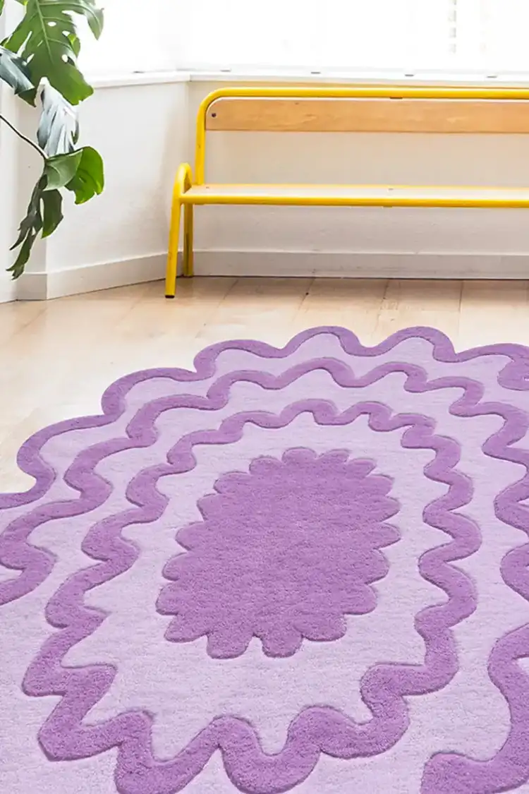 Purple scalloped rug in a bright room, customized to fit a unique interior style