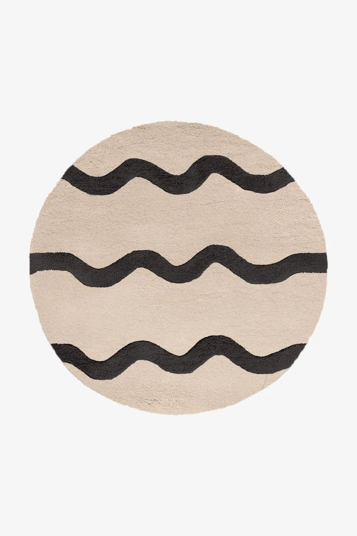 8 ft round cream and black modern tufted rug with sculptural wavy stripes, great for Japandi or minimal interiors