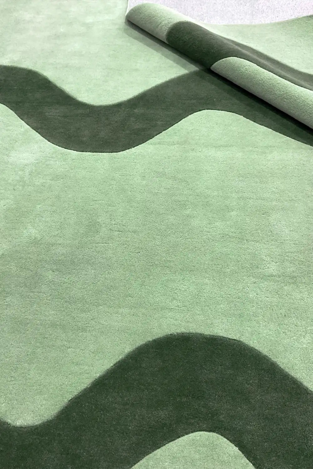 sage green and dark green hand tufted square rug with wavy stripe design