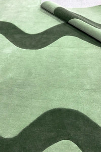 Custom green square rug with whimsical wavy pattern, styled for modern playrooms, entryway rugs, or casual living rooms