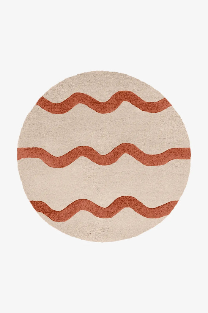 6 foot round cream and terracotta tufted wool rug with playful wavy stripe design, ideal for modern boho rooms