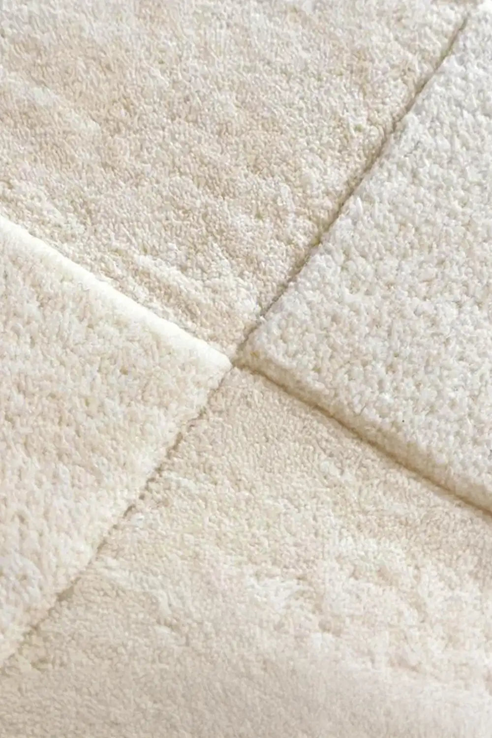 Soft cream checkered wool rug with a plush texture and modern design