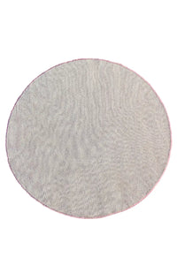 Hand-tufted round rug featuring a modern botanical floral pattern pink blue
