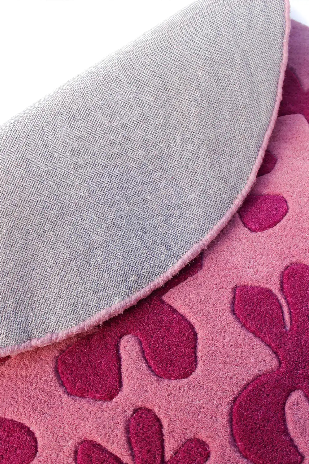Underside of pink floral circle rug showing quality wool weave, 8 ft round rug design