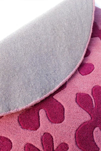 Underside of pink floral circle rug showing quality wool weave, 8 ft round rug design