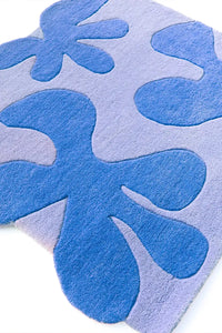 Blue and periwinkle floral tufted square rug with raised 3D shapes