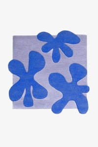 Square wool rug in two-tone blue with hand-tufted abstract flower forms