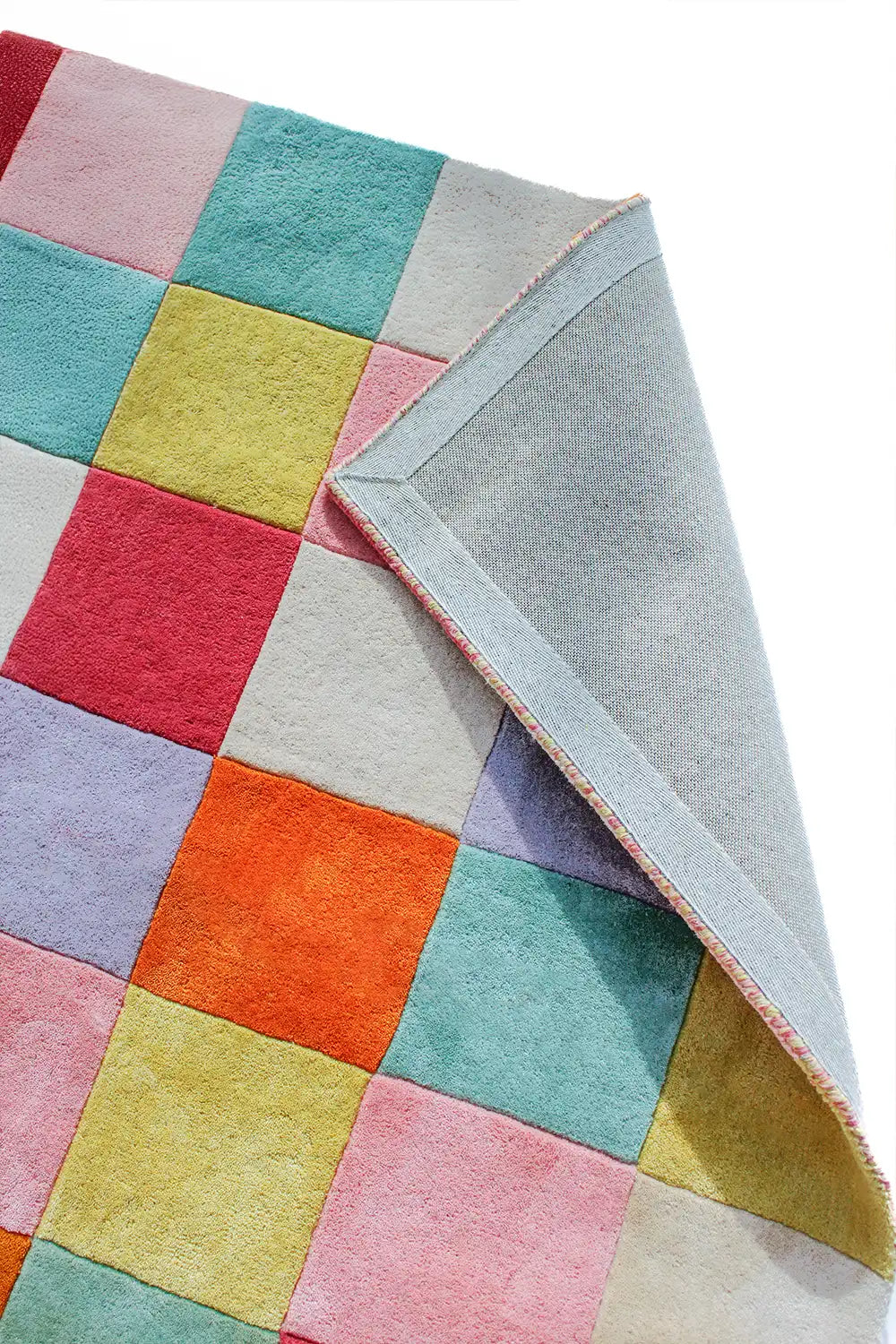 Soft, colorful wool rug featuring a bold square checkered design