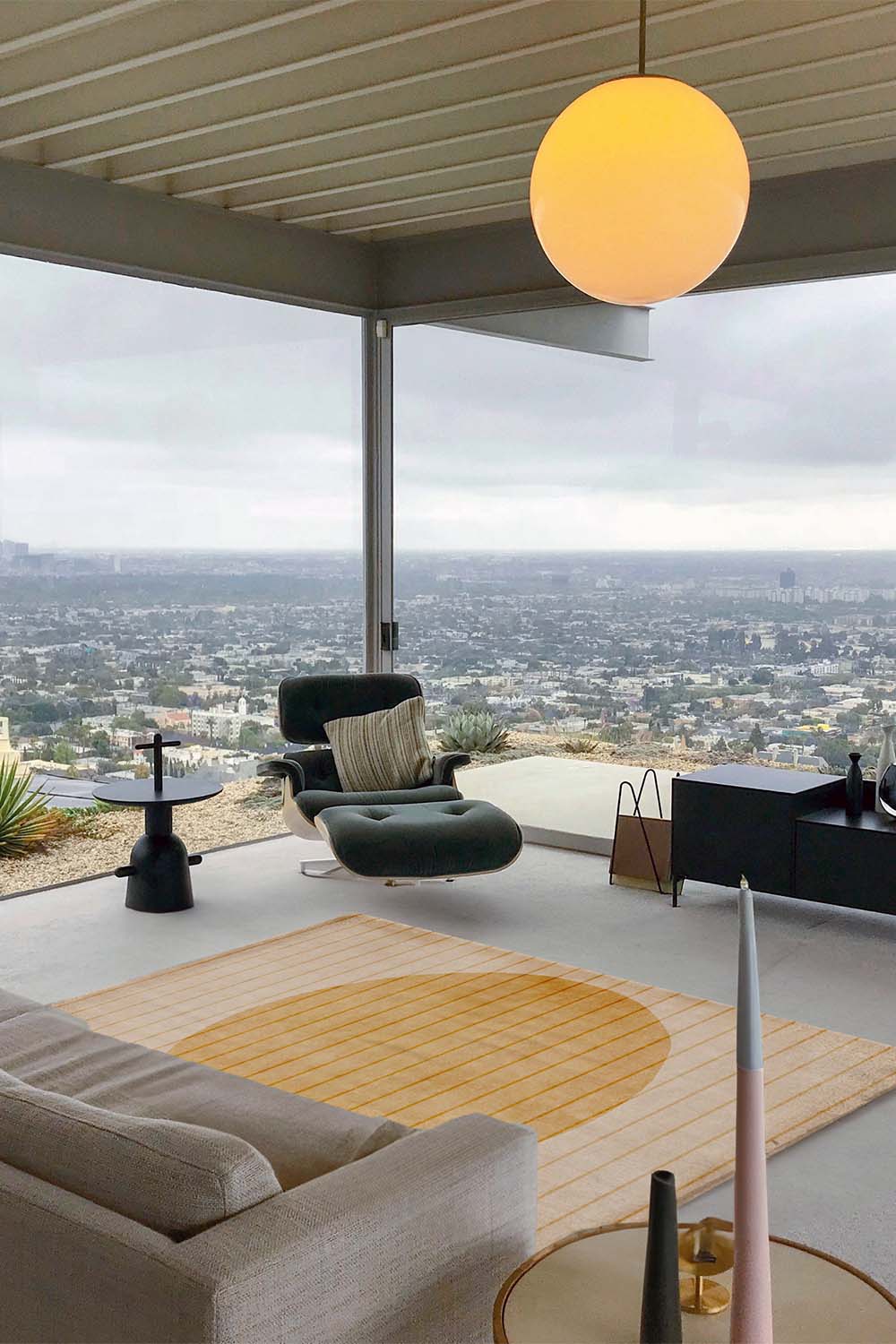 Neutral golden circle wool rug styled in an open modern living room space, showcasing a warm, earthy organic design lifestyle