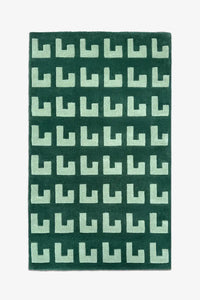 6x9 green and mint geometric wool rug with repeating block pattern, ideal for modern living rooms or offices