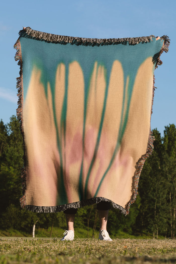 Yellow and blue gradient woven throw blanket with an abstract, organic design.
