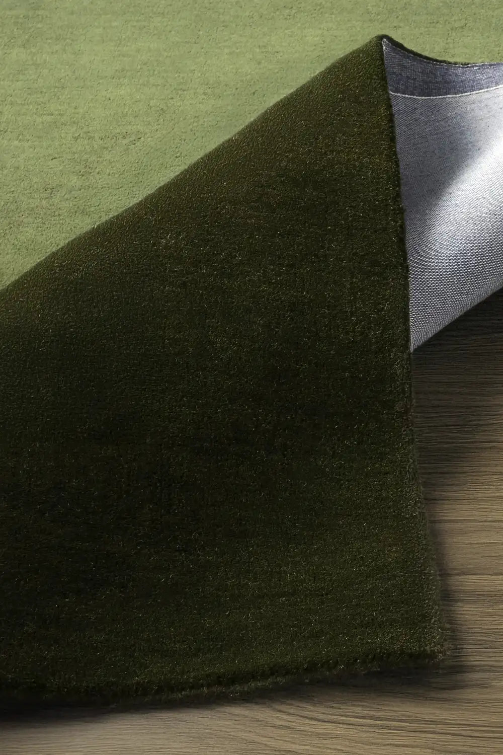 Soft textured close-up of olive green wool square rug, great for neutral nursery decor, natural modern living rooms, or calming minimalist homes