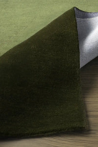 Soft textured close-up of olive green wool square rug, great for neutral nursery decor, natural modern living rooms, or calming minimalist homes