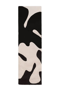 A bold wool runner rug with an eye-catching abstract design in classic black and crisp white