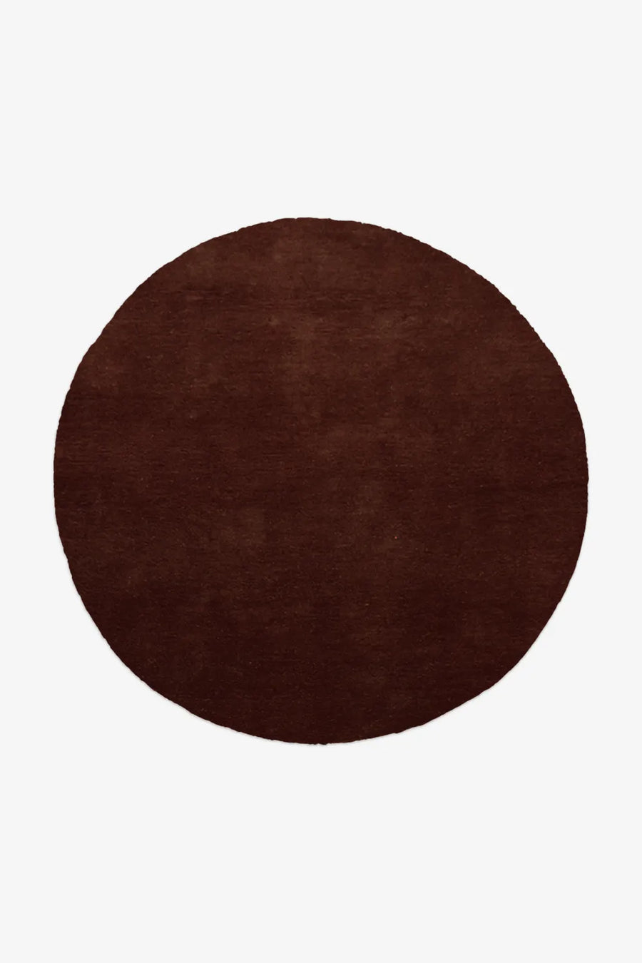 Solid chocolate brown round wool rug with hand-tufted pile
