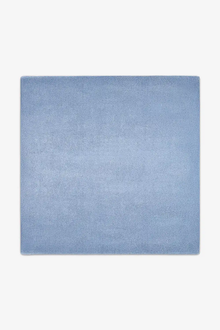 Soft light baby blue wool square rug styled in 9x9 or 11x11 sizes, perfect for creating a calm modern dining space