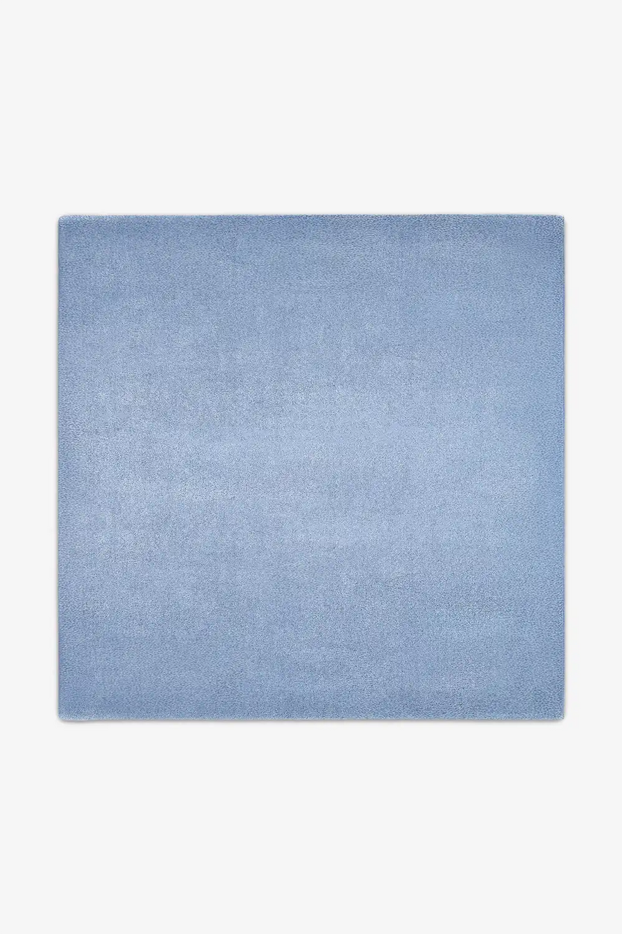 Soft light blue wool square rug styled in 9x9 or 11x11 sizes, perfect for creating a calm modern dining space