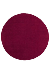 Modern round burgundy rug in wool with smooth surface and deep rich color, ideal for living rooms or bedrooms
