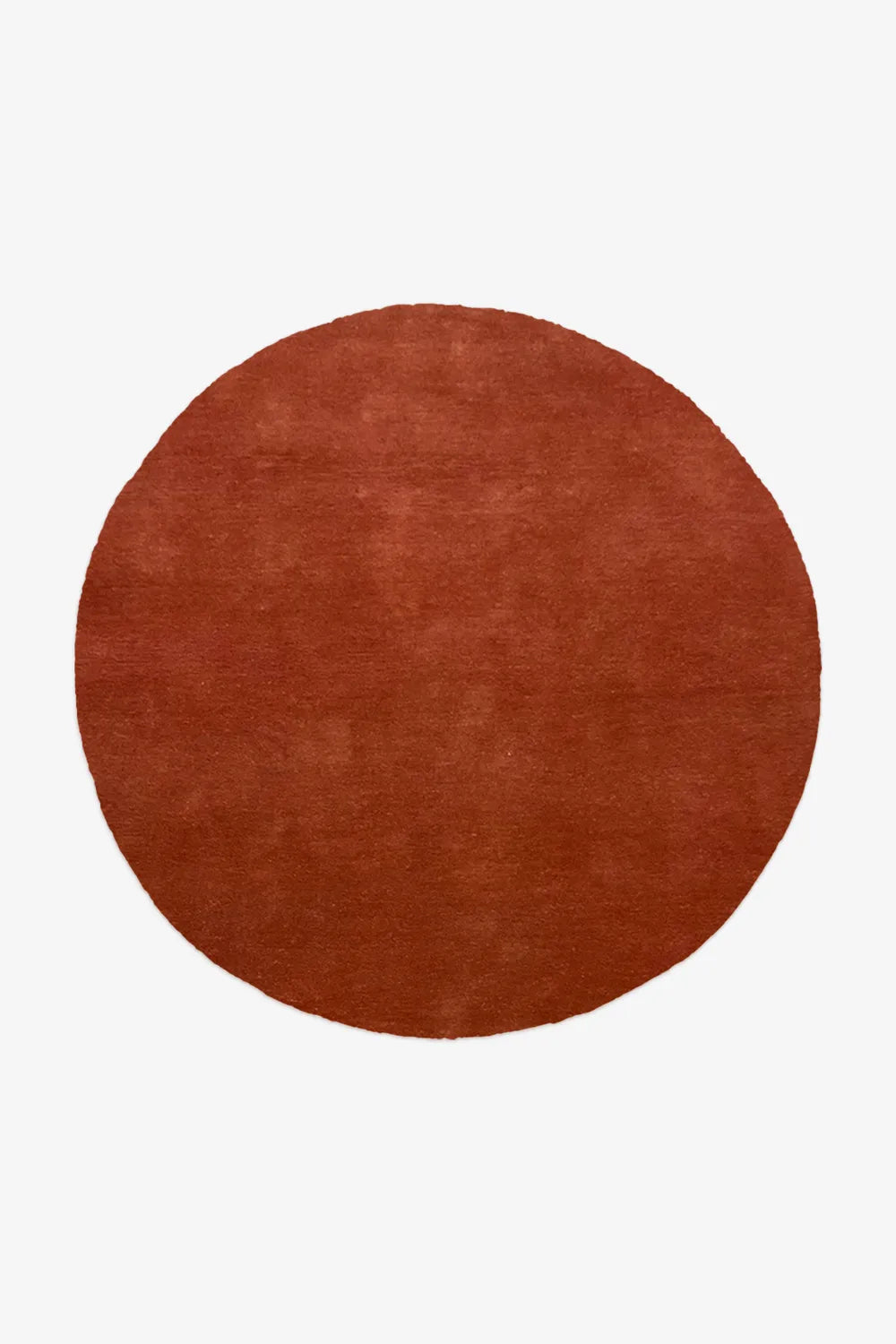 large burnt orange round wool rug in earthy tones, available in 9x9 and 8x8 sizes