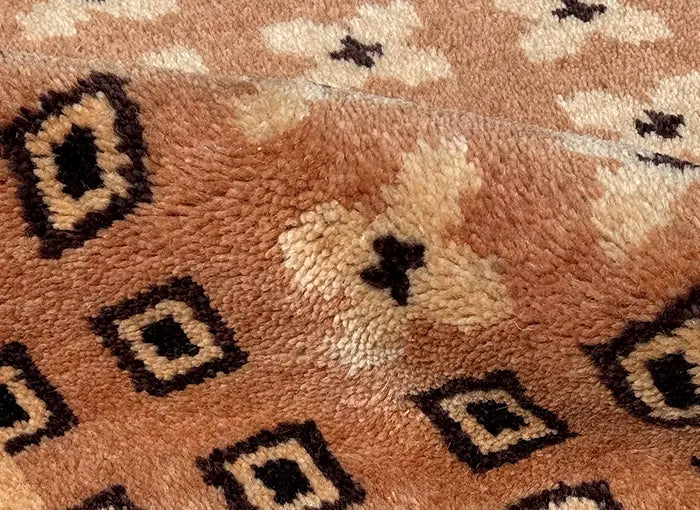 Close-up of a brown textured rug with geometric patterns