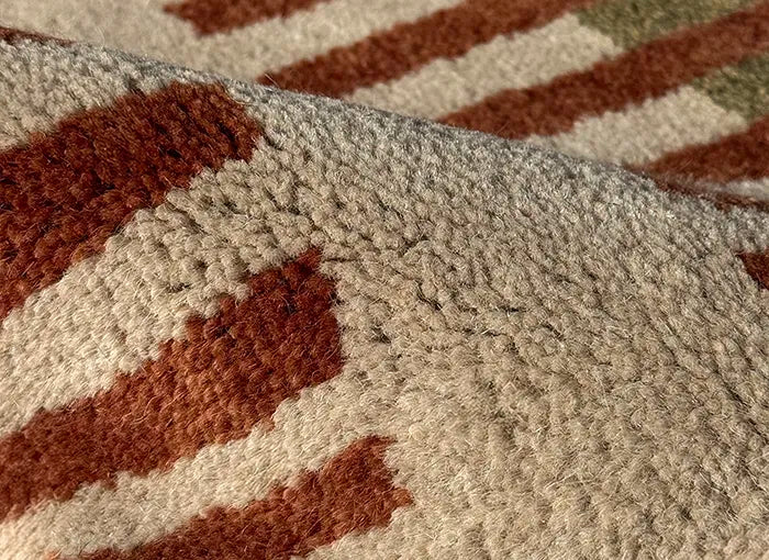 Close-up of a textured rug with brown and beige pattern