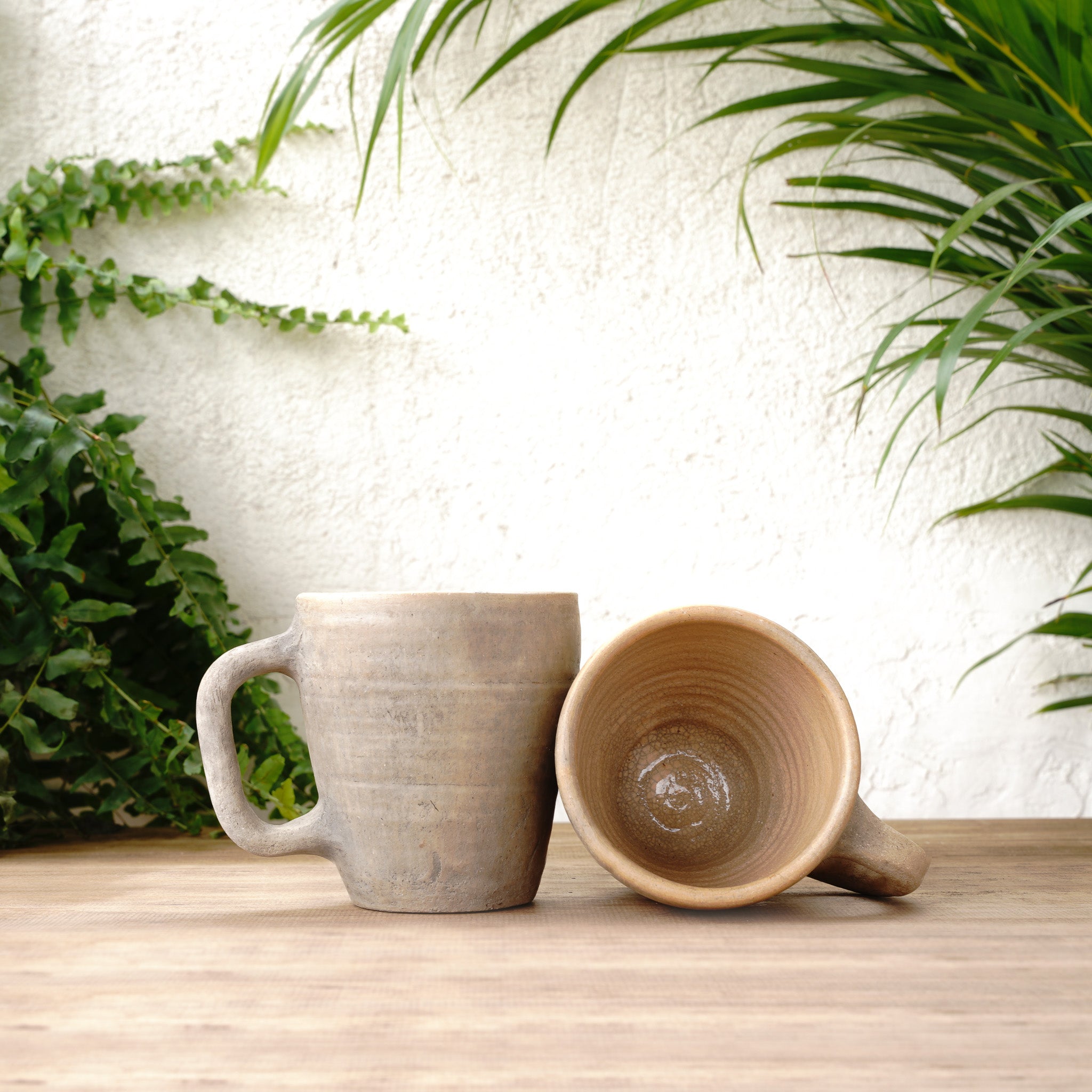 Beige Marble Ceramic Mug on a wooden table, highlighting its rustic charm.