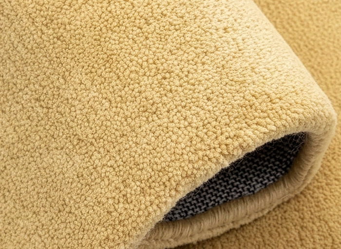 Close-up of a light yellow wool rug