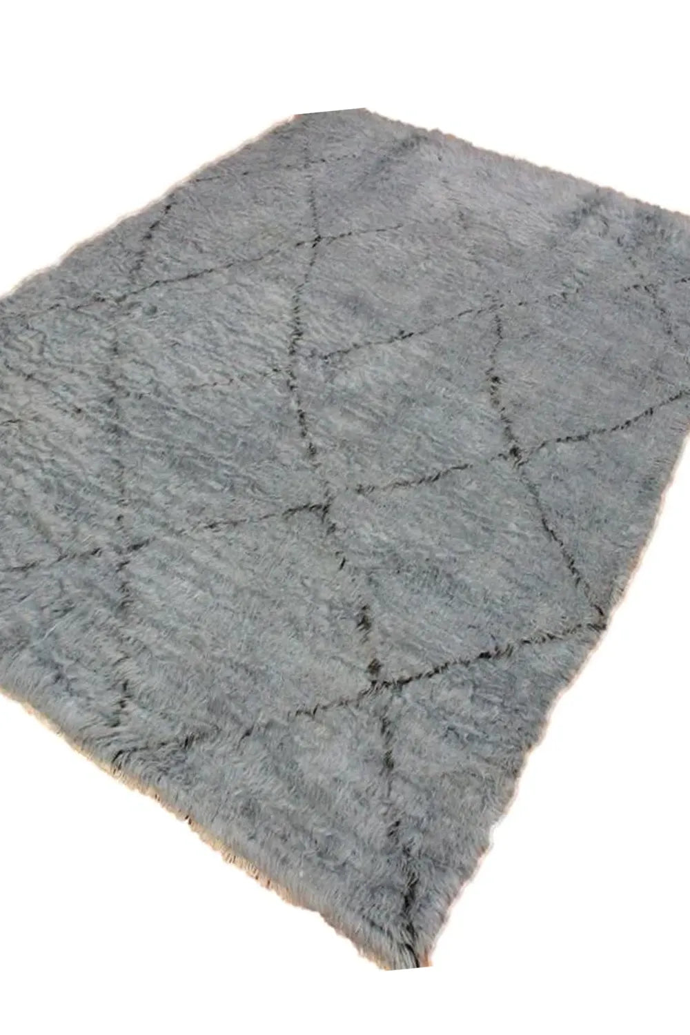 Gray shag rug with a plush pile and large dark gray diamond design.