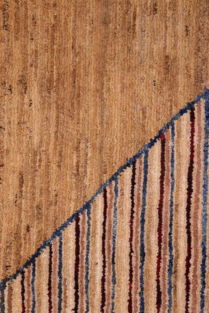 Detail of blue accent stripe woven into neutral brown knotted wool rug, perfect for mcm interiors and earthy modern homes