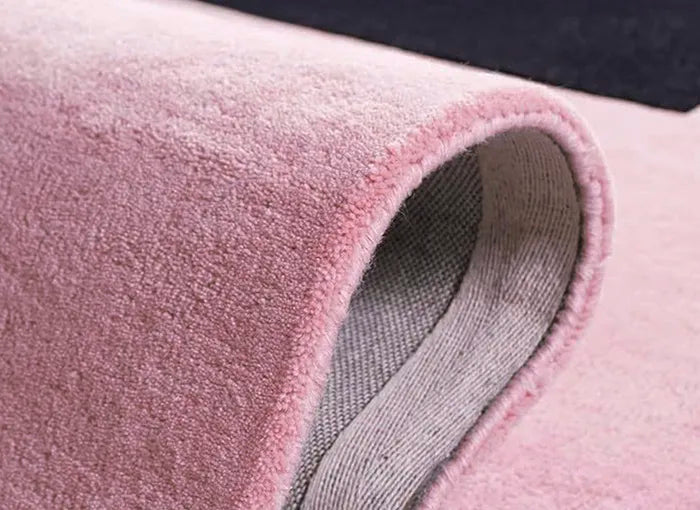 Close-up of pink rug with a textured pattern