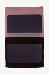 Modern colorblock wool area rug in pink, purple, and black, shown in 5x8 size