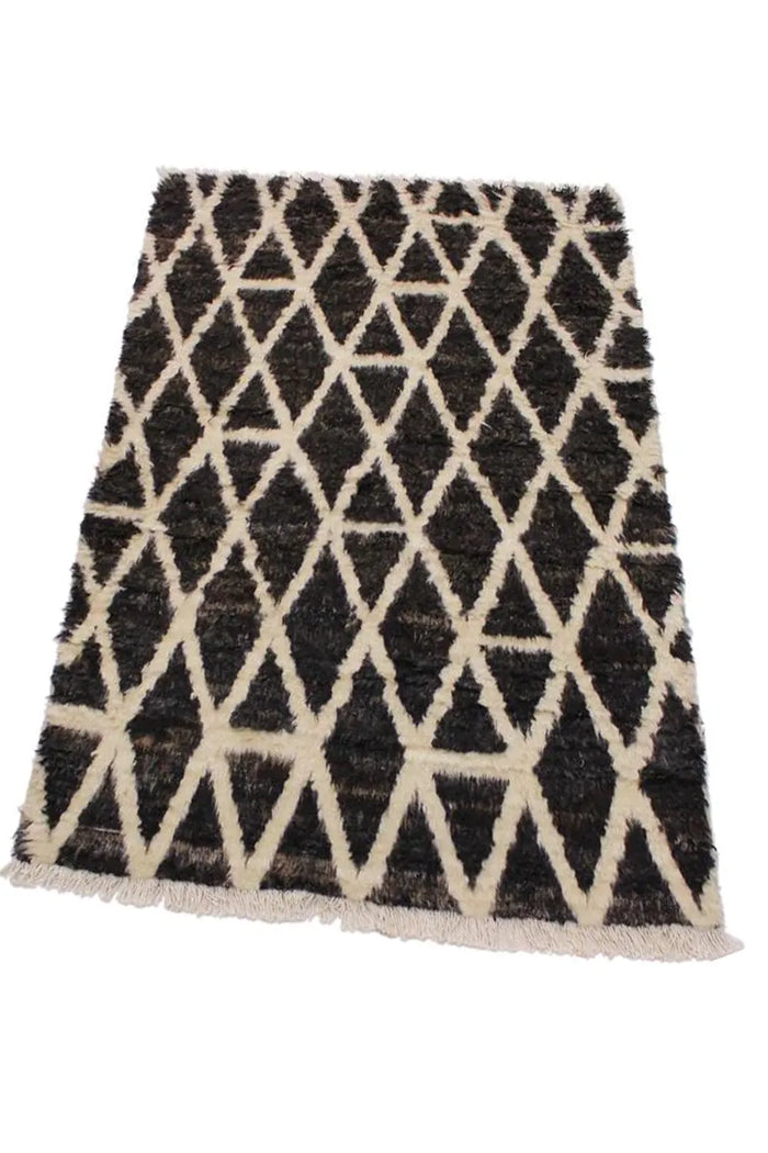Black and ivory Moroccan wool shag area rug shown in 9x12 size, a bold choice for modern living spaces and cozy bedrooms