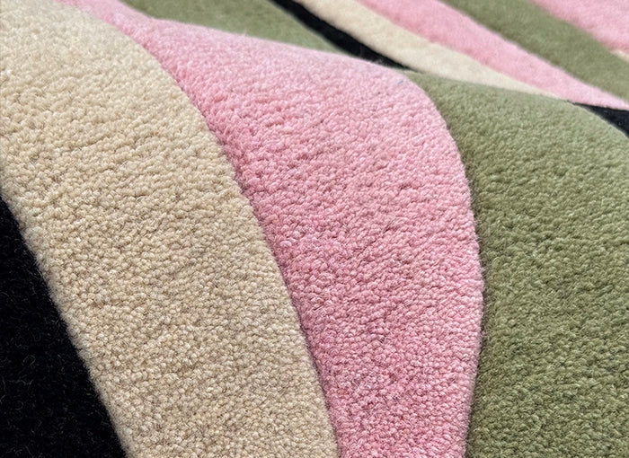 Close-up of contemporary rug with pink and green colors