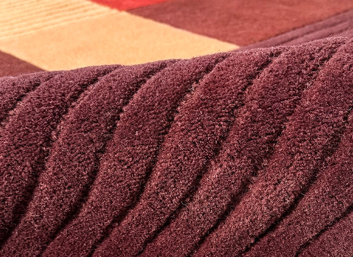 Close-up of a textured brown carpet with geometric pattern