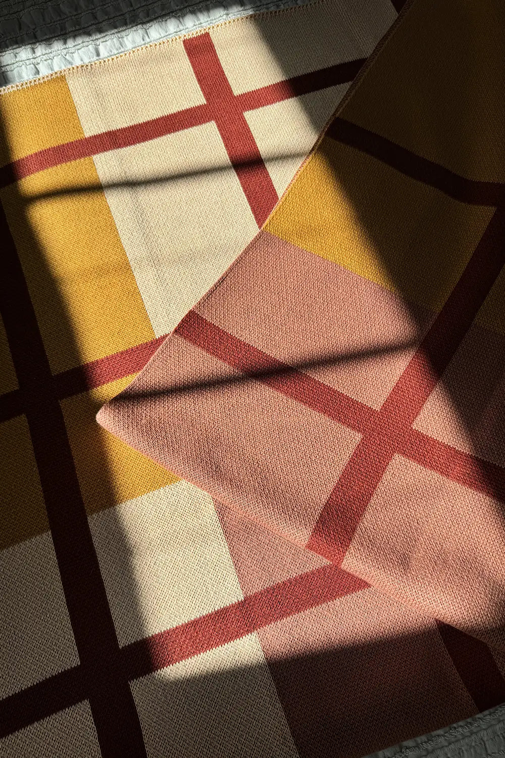 Classic plaid cotton throw blanket with rich earthy tones.
